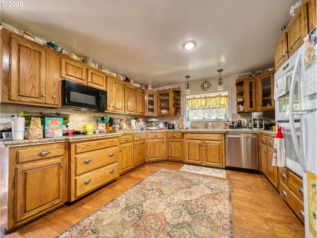 a kitchen with stainless steel appliances granite countertop a stove sink and cabinets