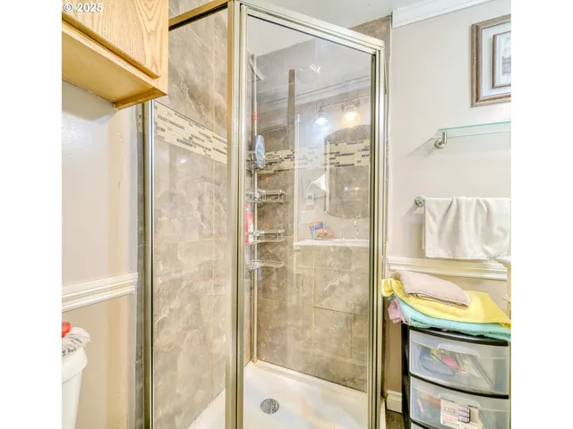 a bathroom with a shower and a sink