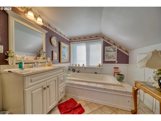 a bathroom with a sink vanity and mirror