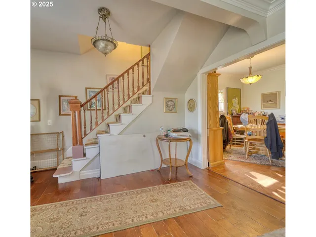 a view of a livingroom with furniture and staircase
