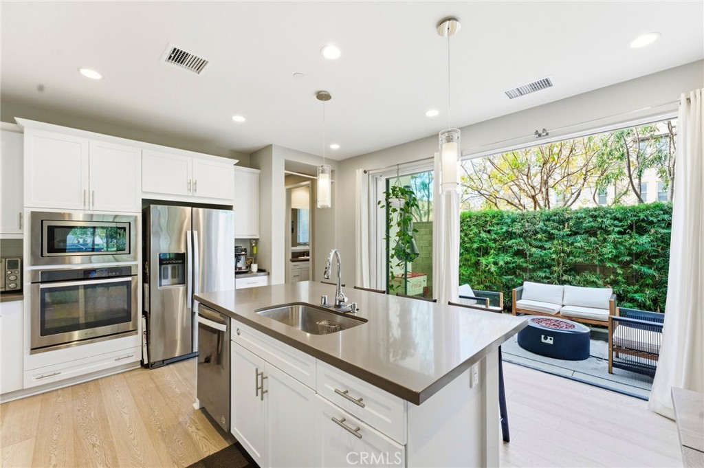 330 Magnet Irvine, CA 92618 - Photo 1 of 1 a kitchen with a stove a sink and a refrigerator