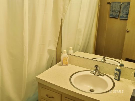 71 Adams Road Wofford Heights, CA 93285 - Photo 9 of 27 a bathroom with a sink and a mirror