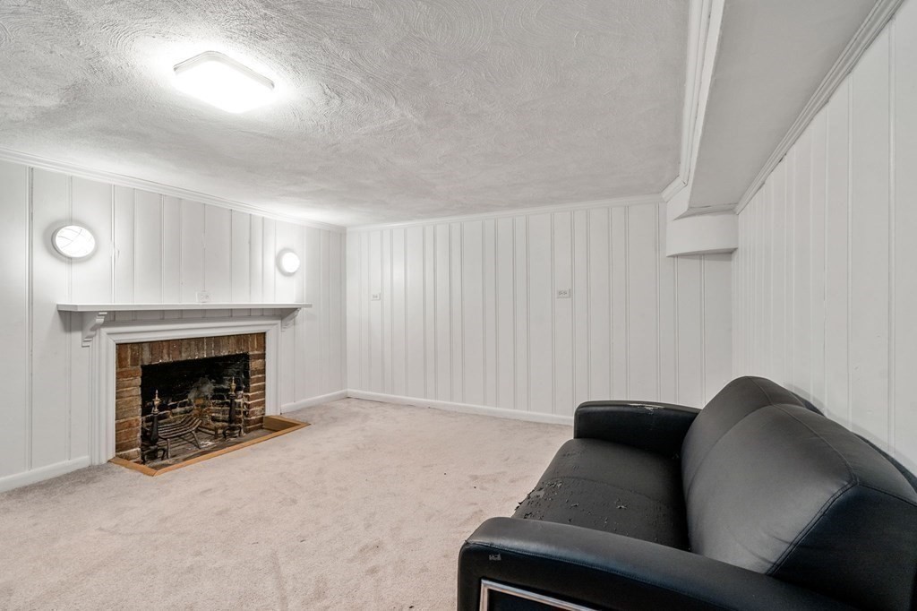 23 Ashford Road Newton, MA 02459 - Photo 25 of 35 a living room with furniture and a fireplace