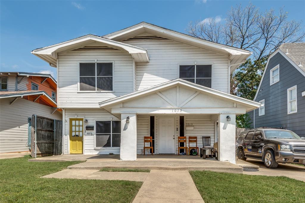 a front view of a house with a yard and porch