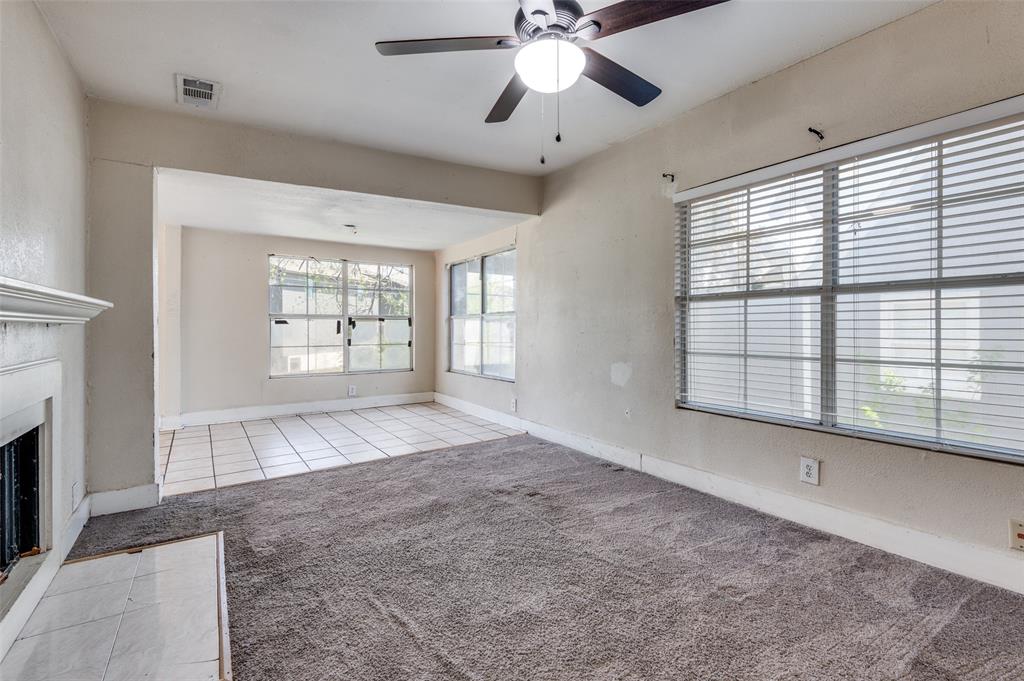 1015 Kings Highway Dallas, TX 75208 - Photo 3 of 15 a view of an empty room with a window and a kitchen