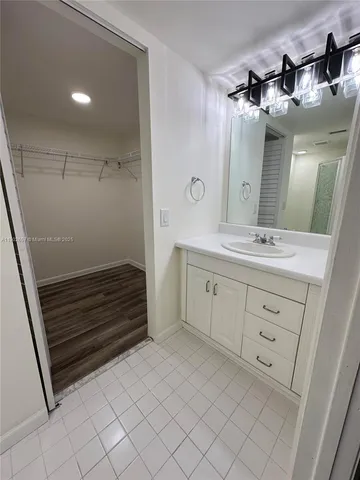 a bathroom with a sink a mirror and a shower