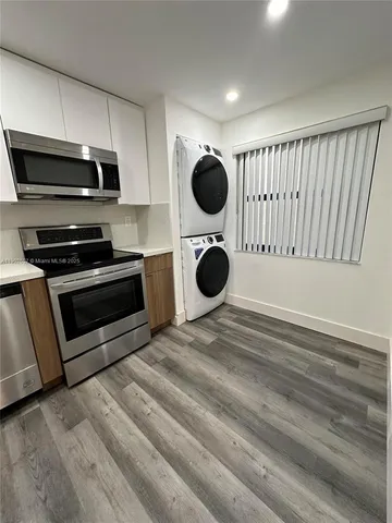 a kitchen with a stove and a microwave