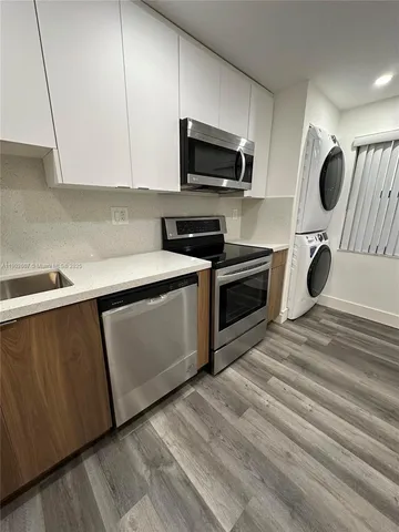 a kitchen with a sink a stove and oven