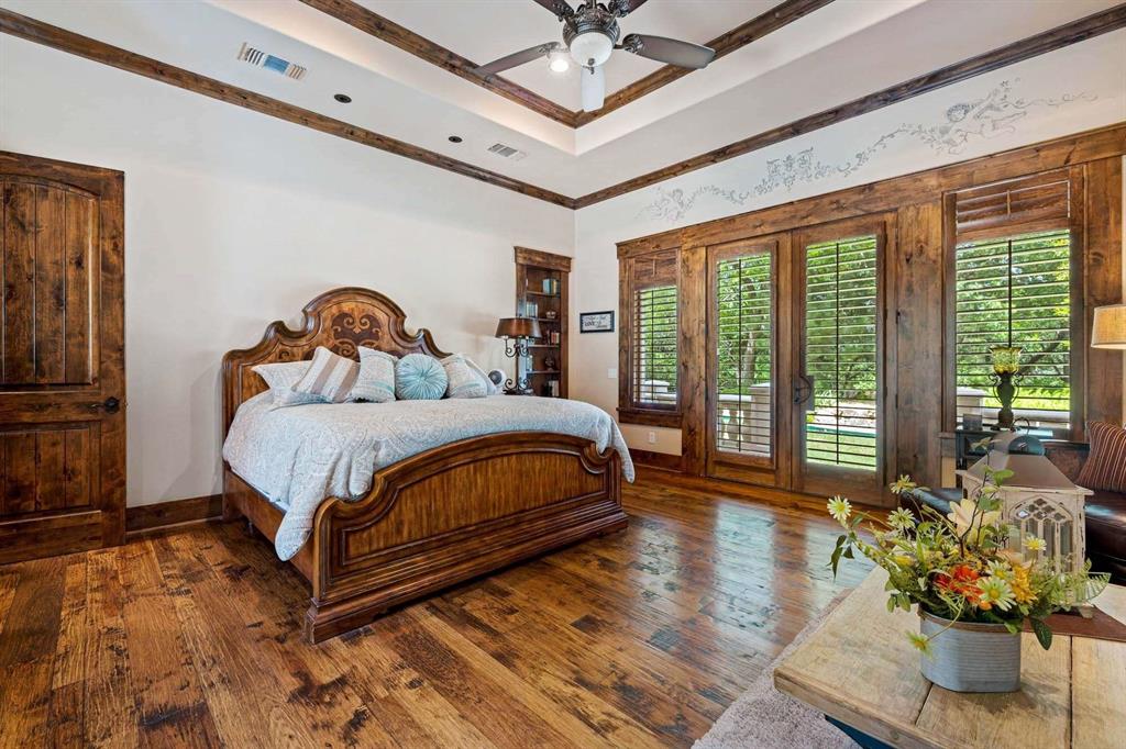 2115 Paradise Rnch Trail McKinney, TX 75071 - Photo 29 of 40 Spacious room featuring wood-finish flooring, a tray ceiling with exposed wood beams, and a ceiling fan
