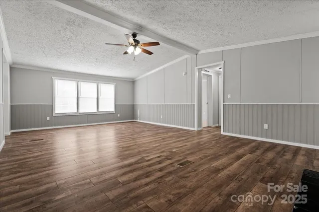 a view of wooden floor and windows in a room