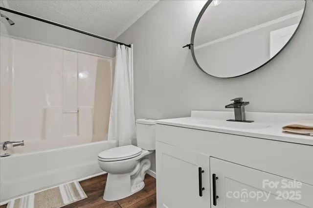 a bathroom with a sink toilet and a mirror