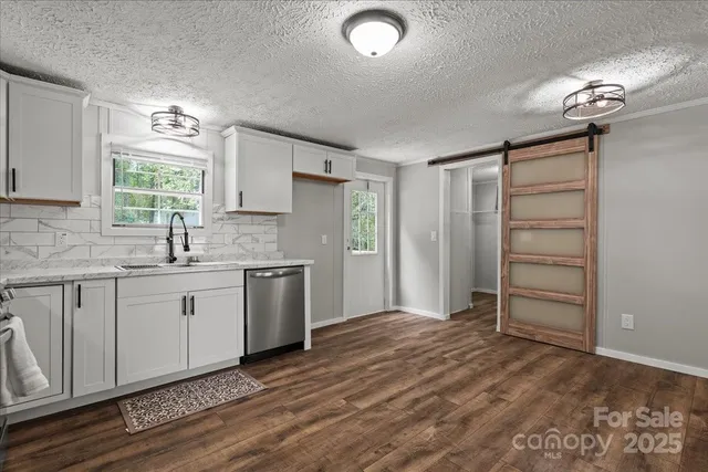 a kitchen with a sink cabinets and window