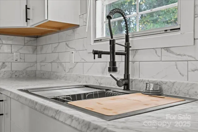 a stove top oven sitting inside of a kitchen