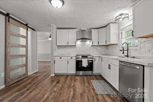a kitchen with a sink window and cabinets