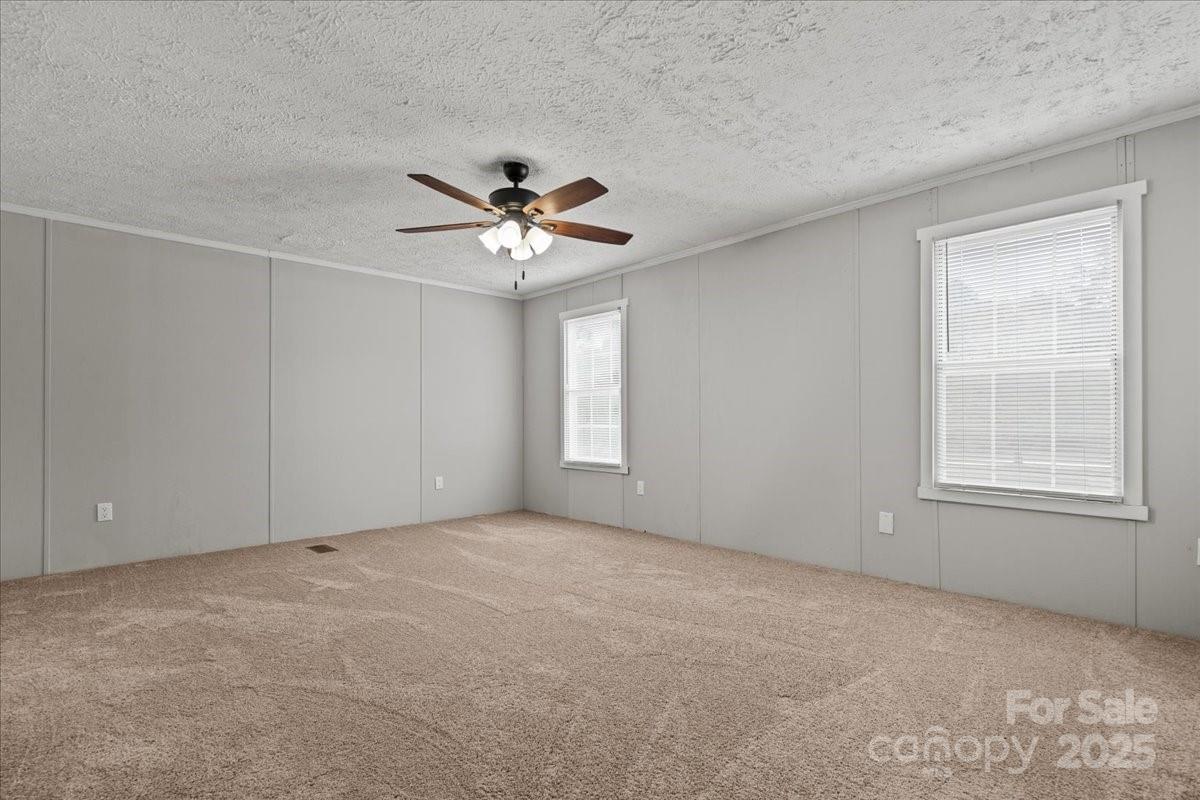 273 Adams Road Chesterfield, SC 29709 - Photo 30 of 47 an empty room with windows and fan