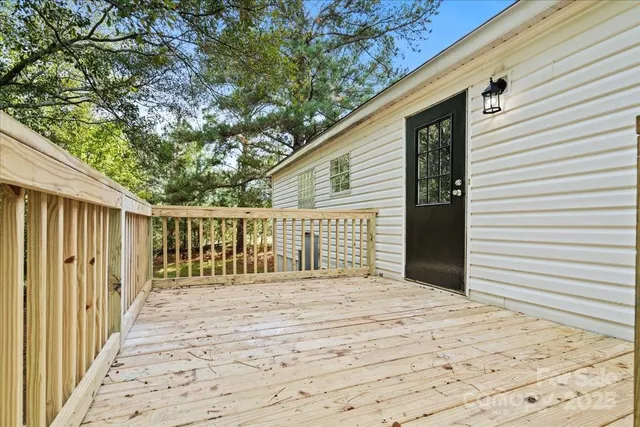 a view of a house with a wooden deck