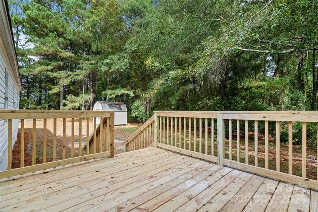 a view of balcony with wooden floor and fence