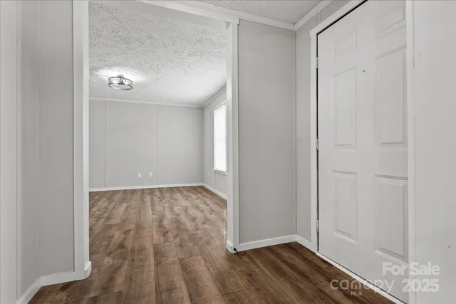 a view of a small space with wooden floor and a hallway