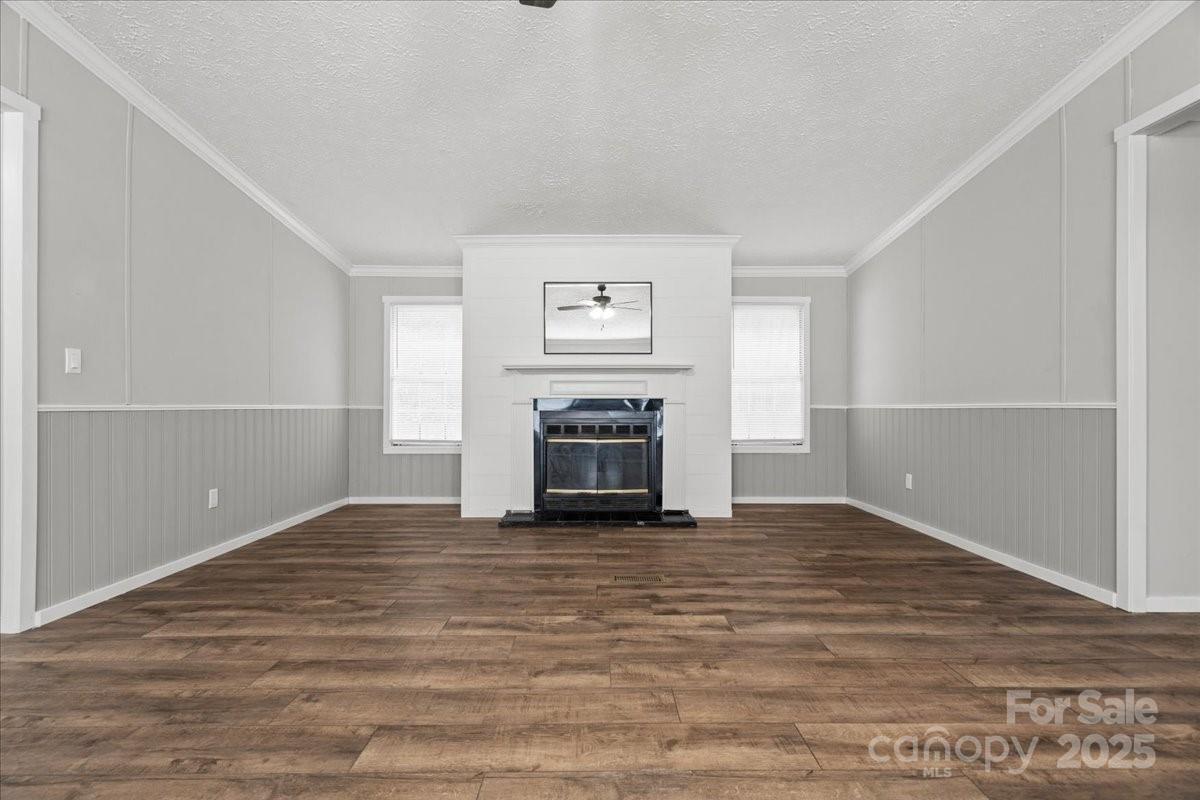 273 Adams Road Chesterfield, SC 29709 - Photo 10 of 47 a view of empty room with wooden floor and fireplace