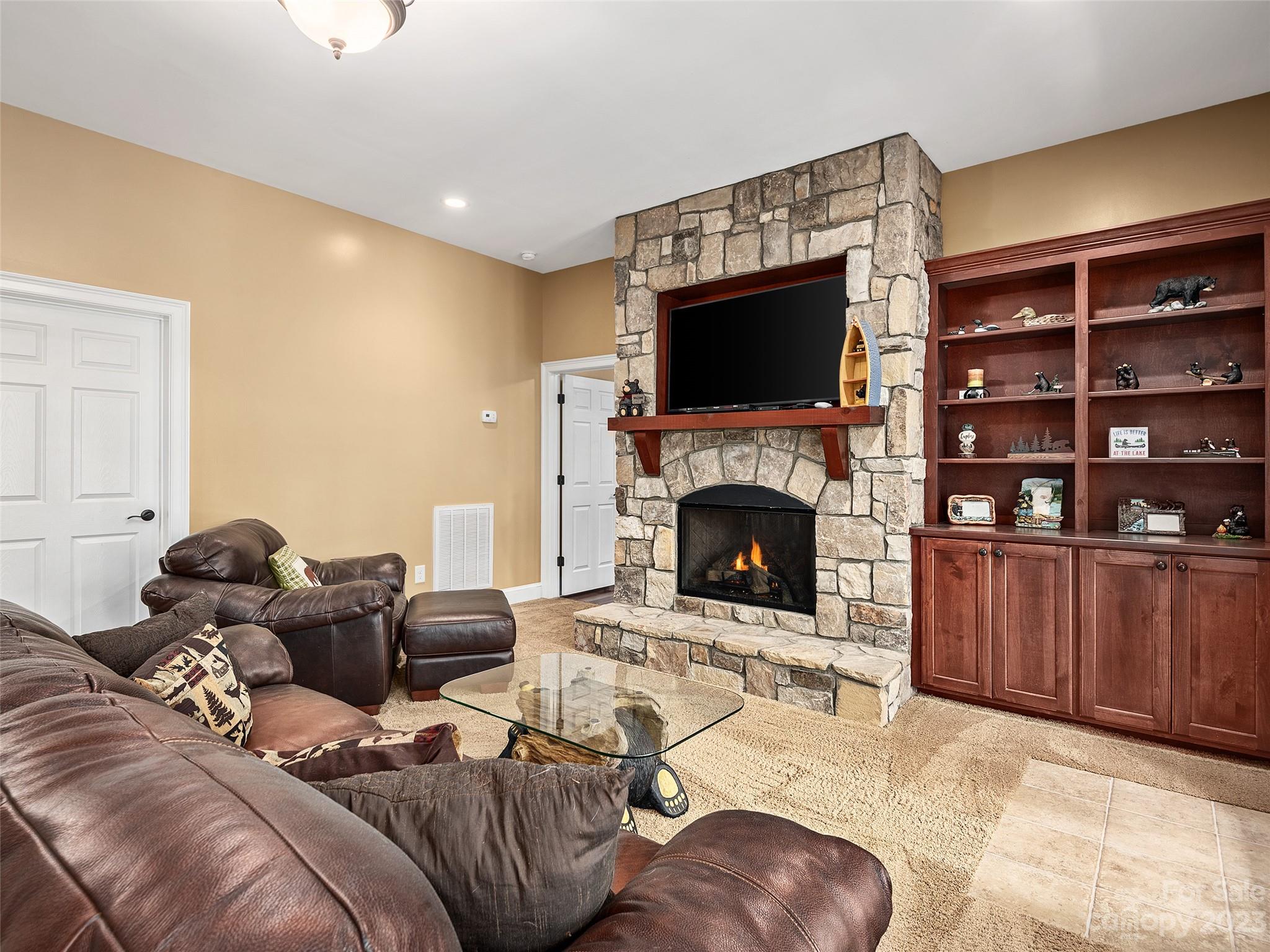1131 South Cove Road Mill Spring, NC 28756 - Photo 33 of 48 a living room with furniture or flat screen tv and a fireplace