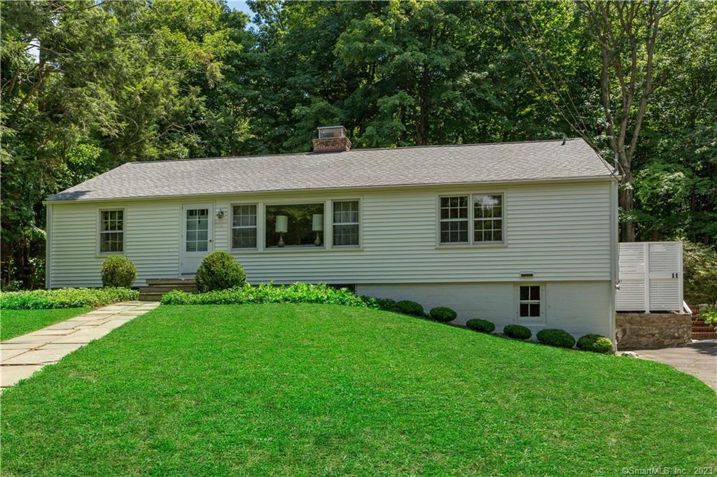 11 Ridgewood Road Wilton, CT 06897 - Photo 1 of 1 surrounded by verdant lawn and green trees