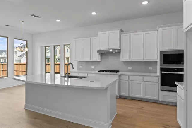 a kitchen with a sink and refrigerator
