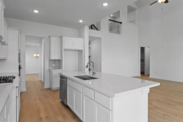 a view of an empty room with window and cabinet