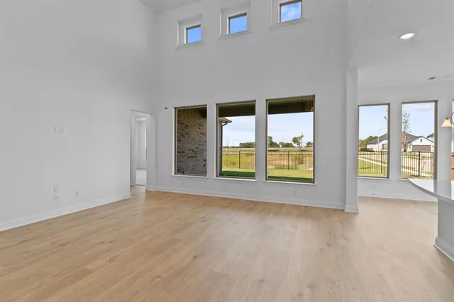 a view of kitchen with kitchen island white cabinets and stainless steel appliances