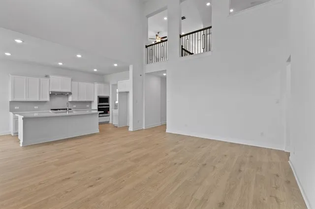 a spacious bedroom with a bed and a chandelier