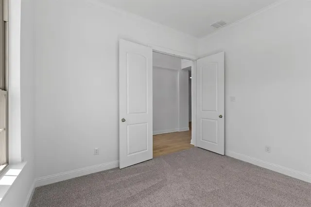 a view of a room with wooden floor staircase and a chandelier
