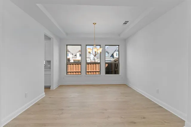a kitchen with stainless steel appliances a dining table chairs and granite counter tops