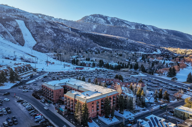 50 Shadow Ridge Road, Unit 4209 Park City, UT 84060 - Photo 2 of 50 Mountain backdrop with snow-covered terrain, surrounding mature trees, multi-level buildings with balconies, and multiple parking areas
