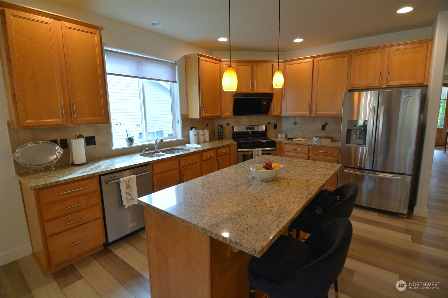 21 233rd Place Southeast Bothell, WA 98021 - Photo 11 of 33 a kitchen with stainless steel appliances granite countertop a sink a refrigerator and a microwave