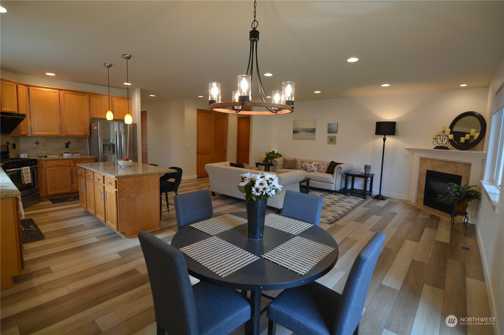 21 233rd Place Southeast Bothell, WA 98021 - Photo 15 of 33 a view of a dining room with furniture a chandelier and wooden floor