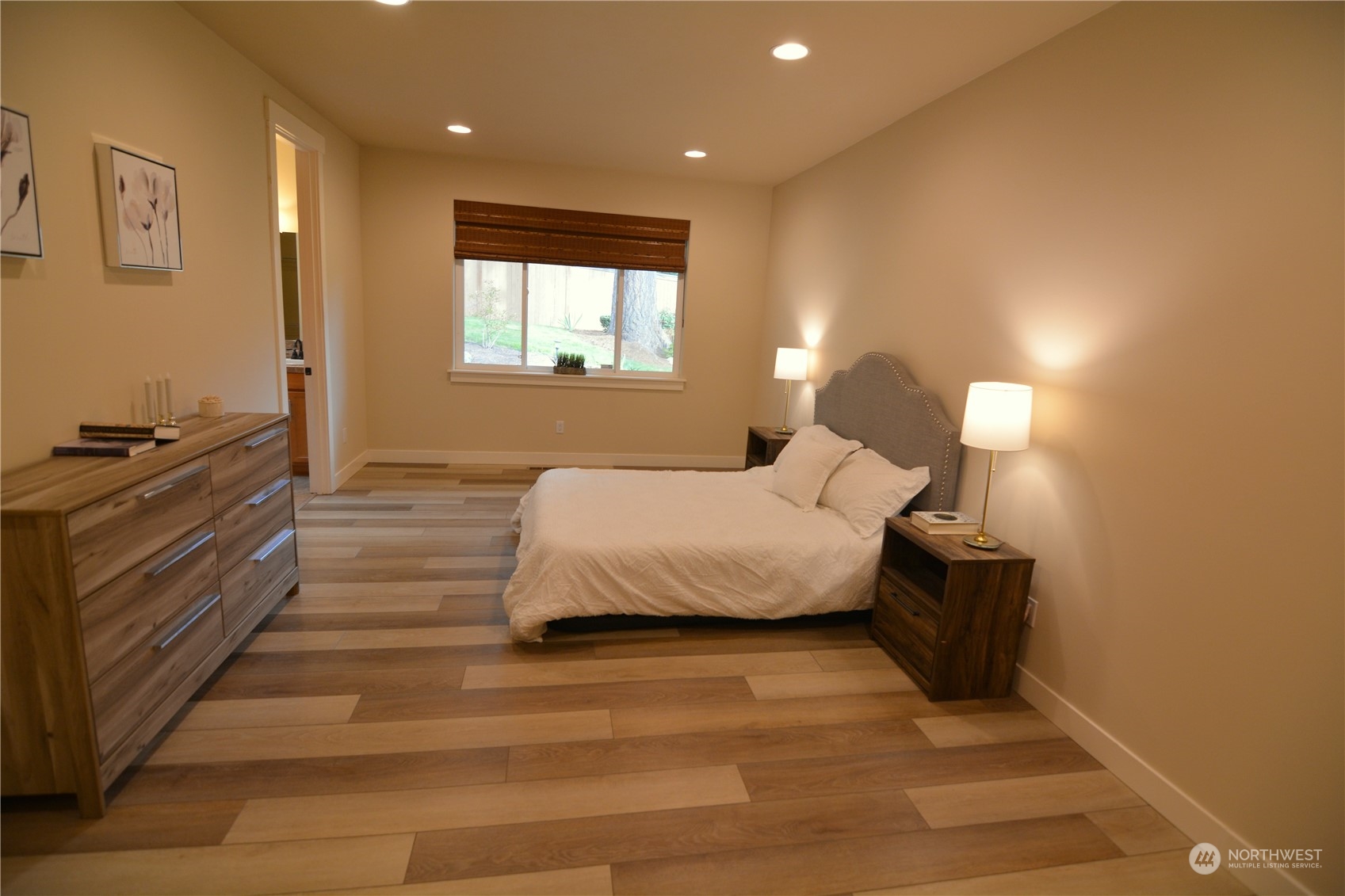 21 233rd Place Southeast Bothell, WA 98021 - Photo 18 of 33 a spacious bedroom with a bed and a lamp