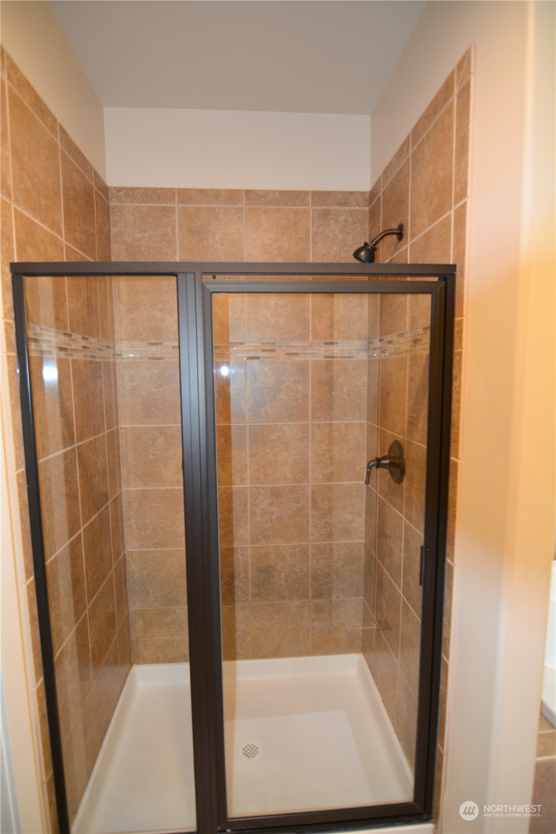 21 233rd Place Southeast Bothell, WA 98021 - Photo 21 of 33 a bathroom with a glass shower door