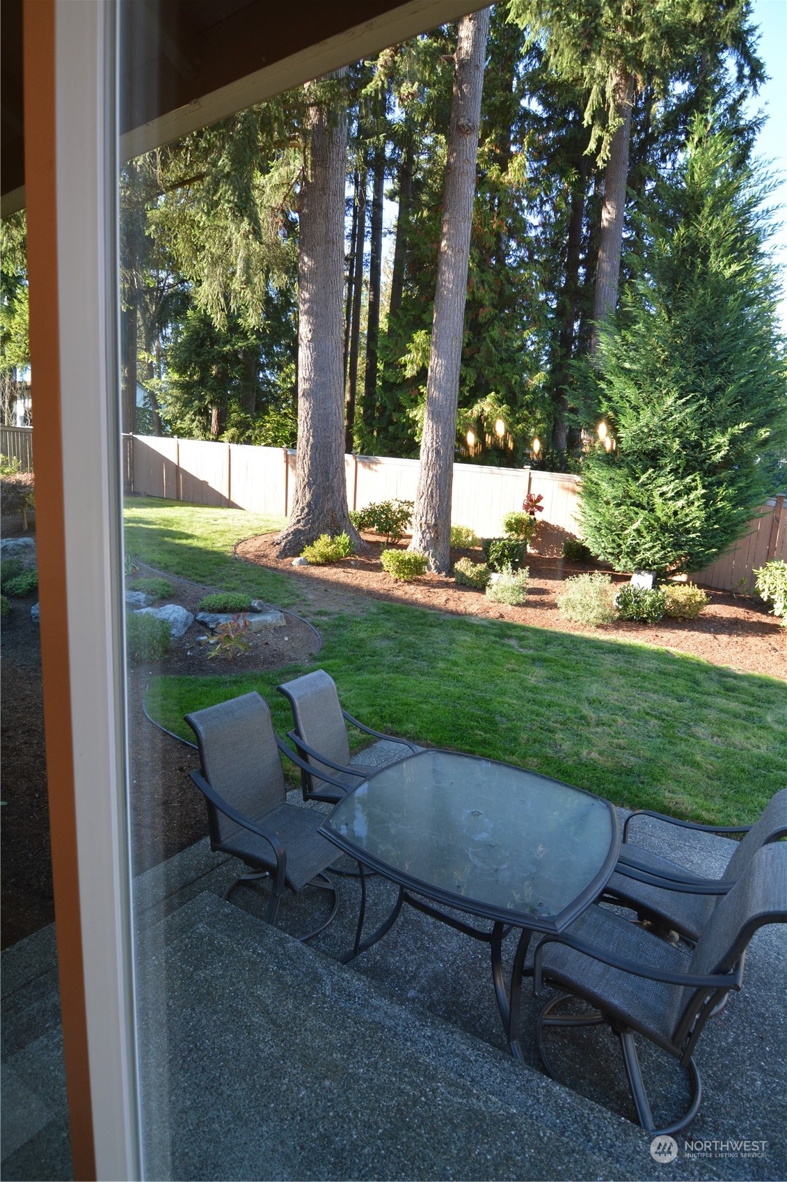 21 233rd Place Southeast Bothell, WA 98021 - Photo 27 of 33 a view of a backyard with sitting area and garden