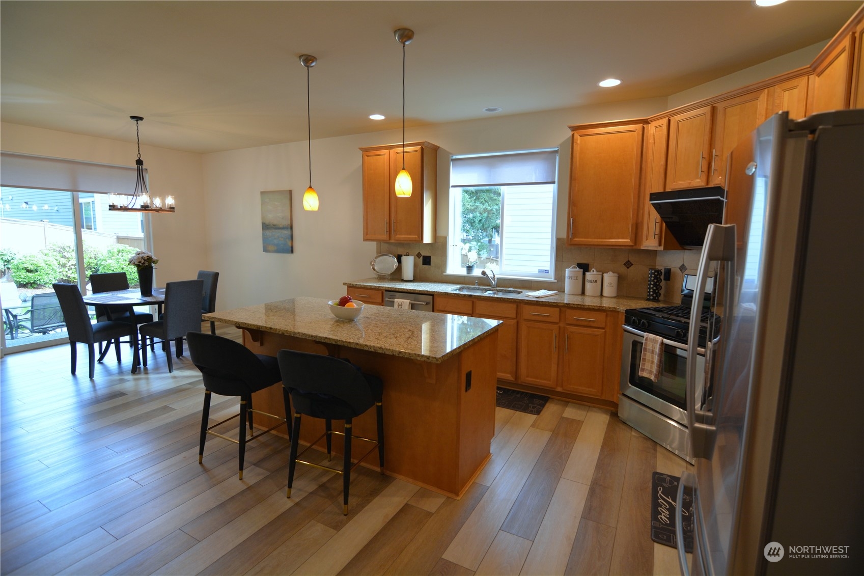 21 233rd Place Southeast Bothell, WA 98021 - Photo 10 of 33 a kitchen with a table chairs refrigerator and microwave