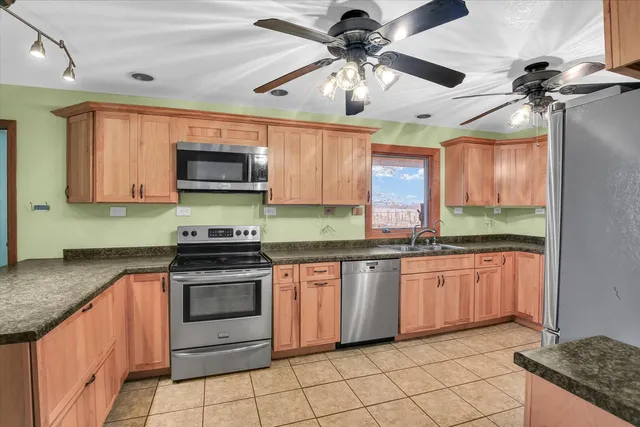 a kitchen with stainless steel appliances a refrigerator and a stove top oven
