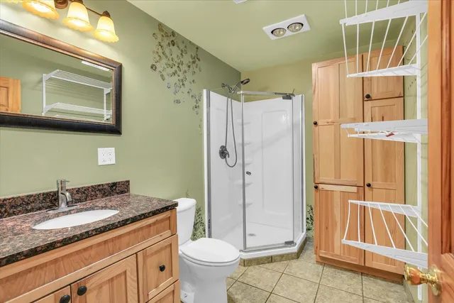 a view of an empty room with closet and a window