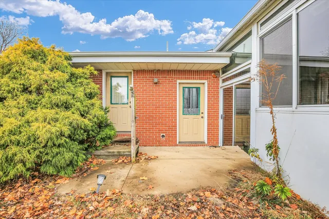 a white toilet sitting next to a bathroom sink and vanity