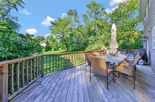 a view of a chairs and table on the wooden deck