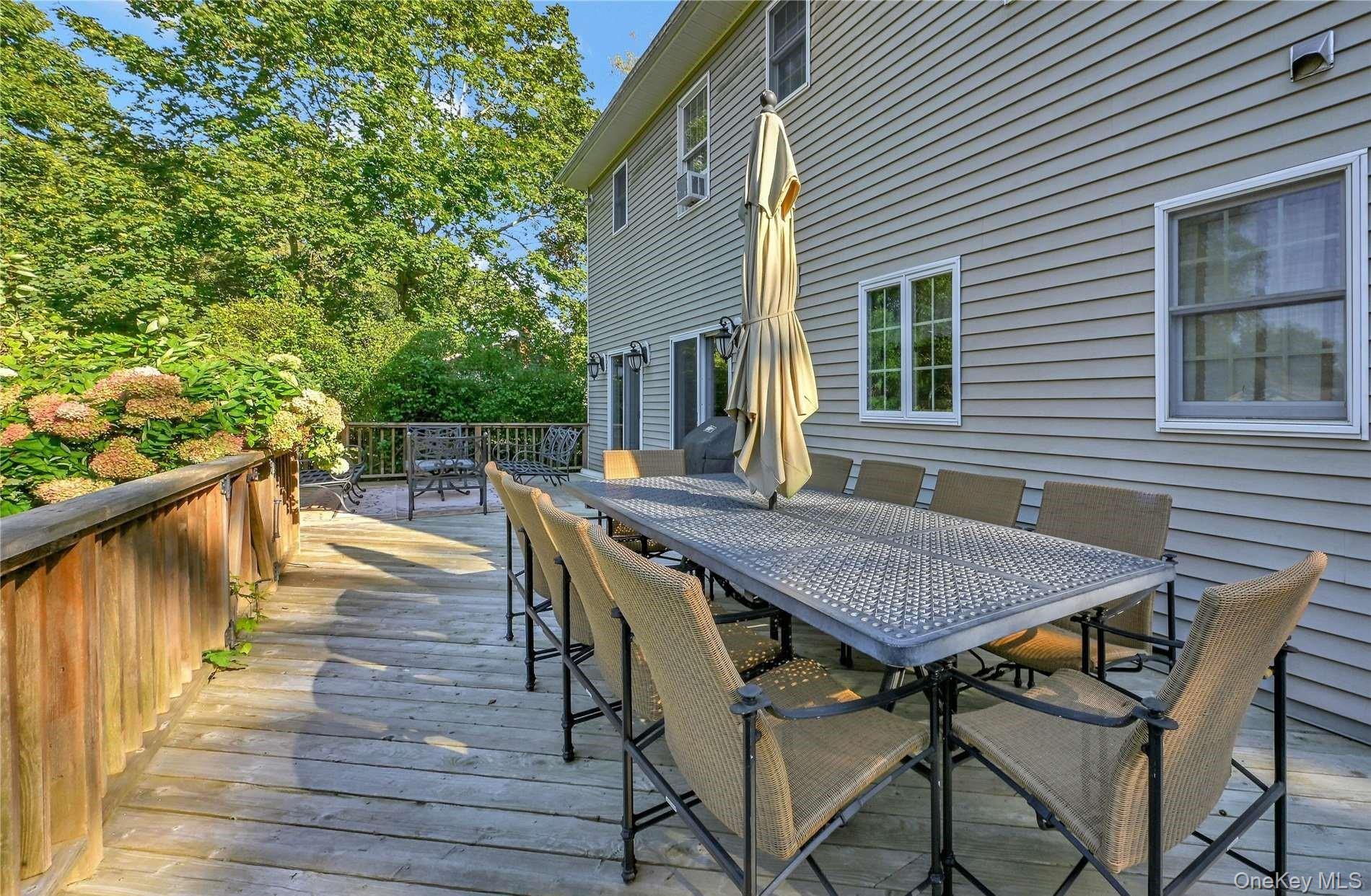 215 Kouros Road New Suffolk, NY 11956 - Photo 12 of 28 a view of a roof deck with table and chairs and wooden floor