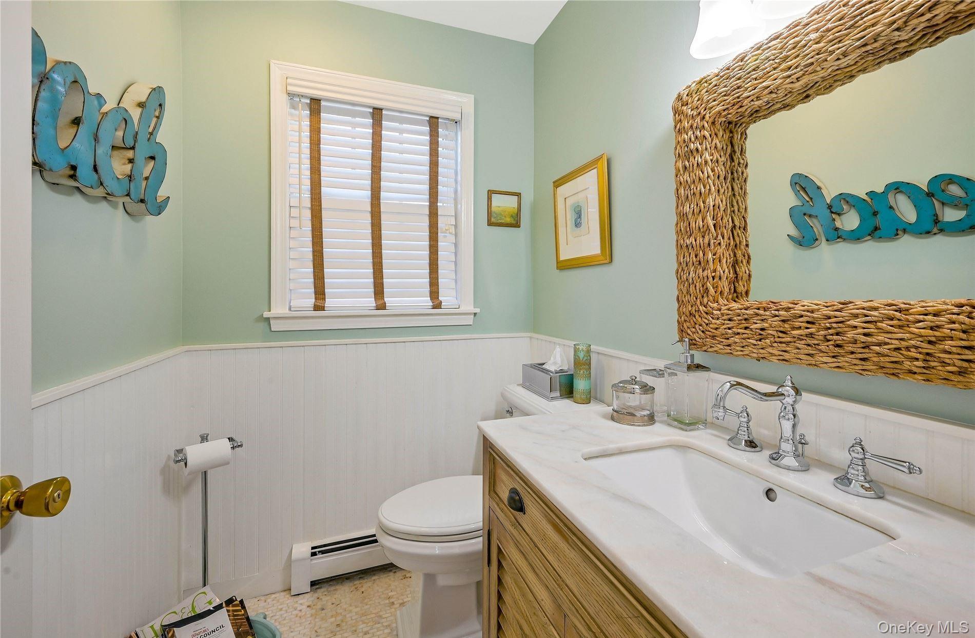 215 Kouros Road New Suffolk, NY 11956 - Photo 15 of 28 a bathroom with a sink mirror vanity and toilet