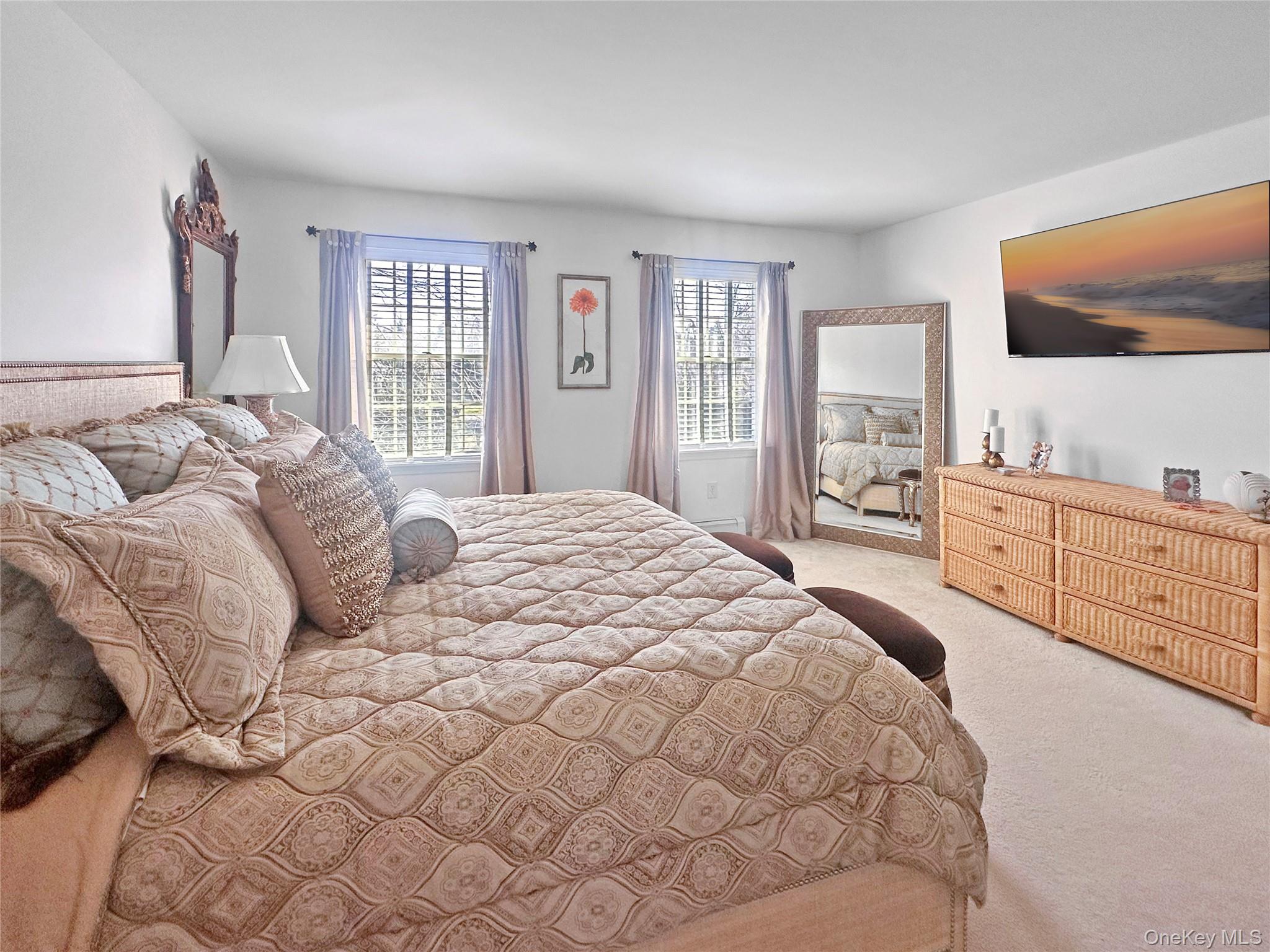 215 Kouros Road New Suffolk, NY 11956 - Photo 17 of 28 a large white bed sitting in a bedroom next to a window