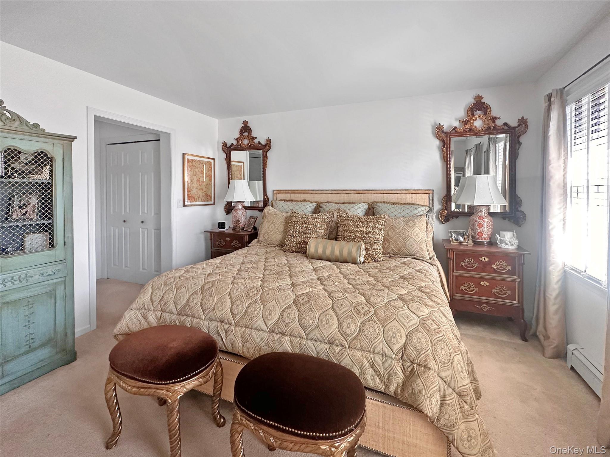 215 Kouros Road New Suffolk, NY 11956 - Photo 18 of 28 a bedroom with a bed and a chair