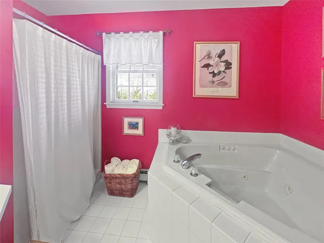 a bathroom with a bathtub and shower