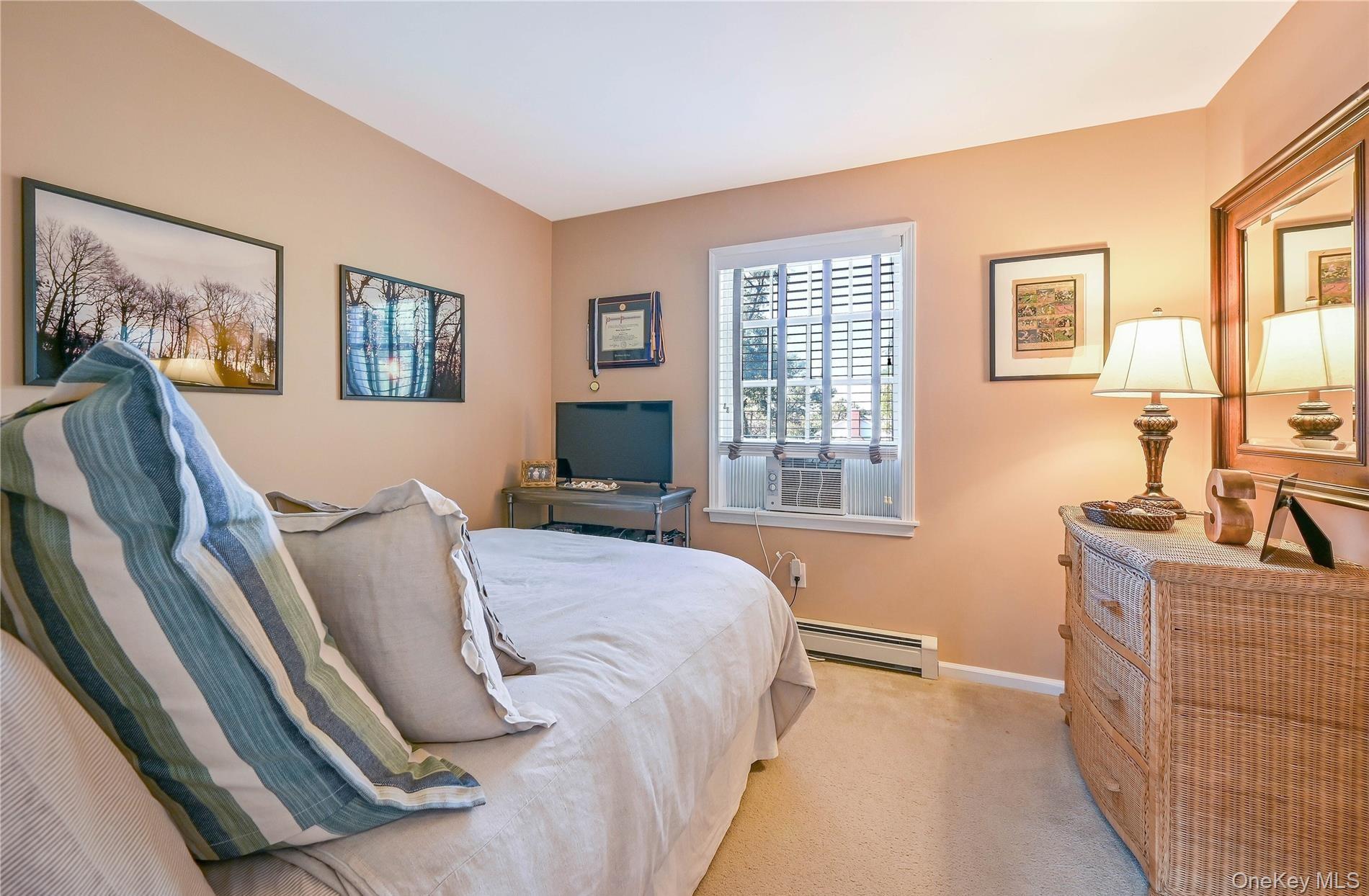 215 Kouros Road New Suffolk, NY 11956 - Photo 21 of 28 a bedroom with a bed and a couch