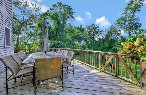 a view of a chairs and table on the wooden deck