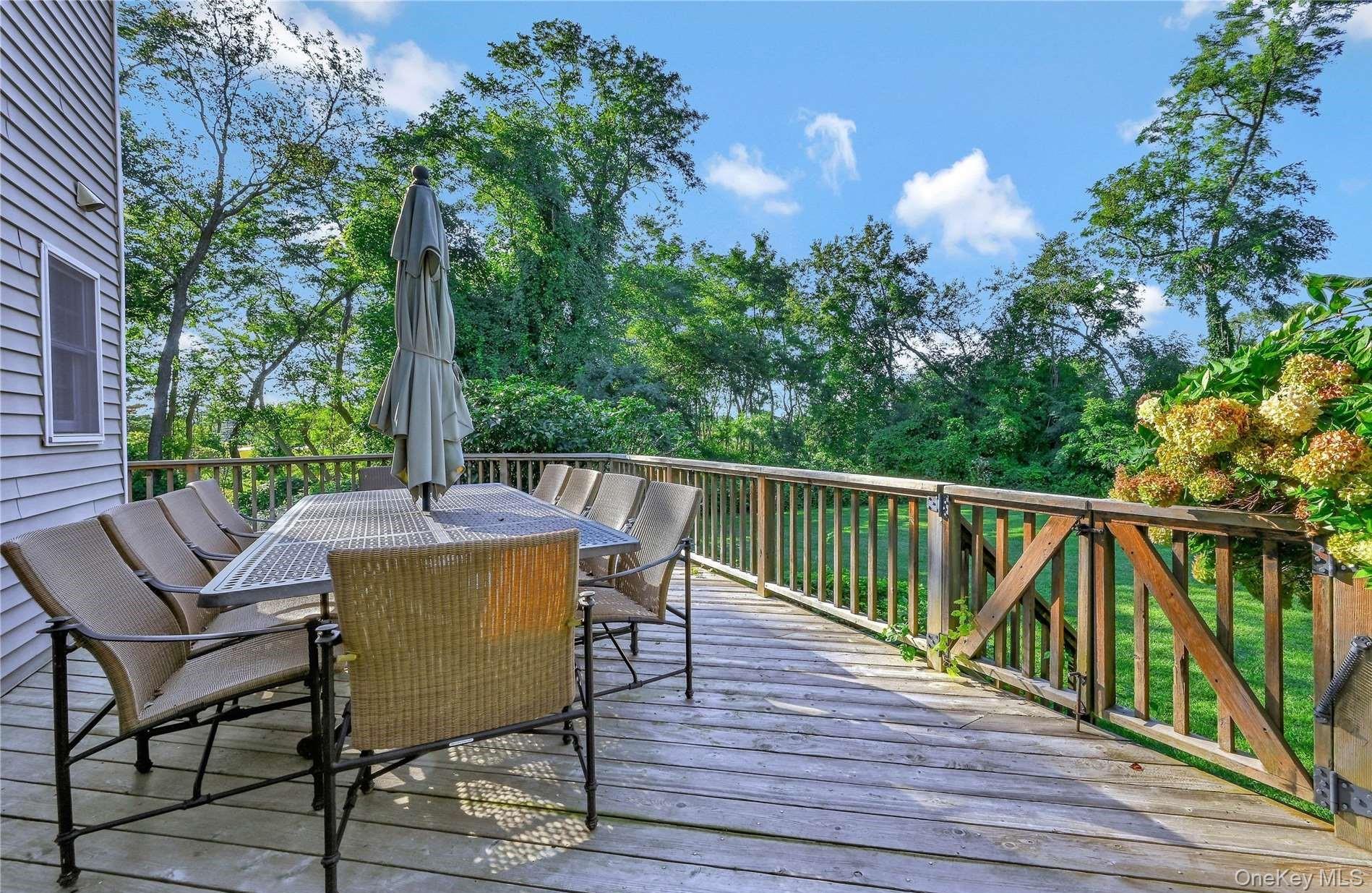 215 Kouros Road New Suffolk, NY 11956 - Photo 27 of 28 a view of a chairs and table on the wooden deck